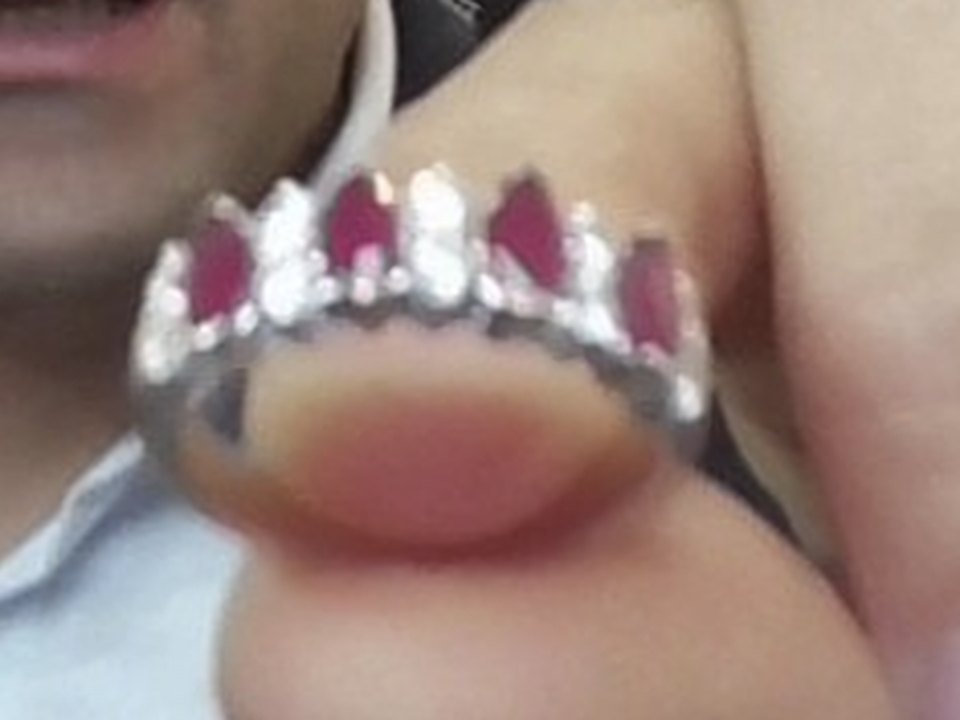 Before: blurry phone photo of a ruby and diamond ring held in fingers